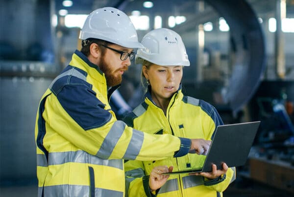 OSHA-Logs-Construction-Crew-with-Hard-Hats-Examaning-a-Tablet