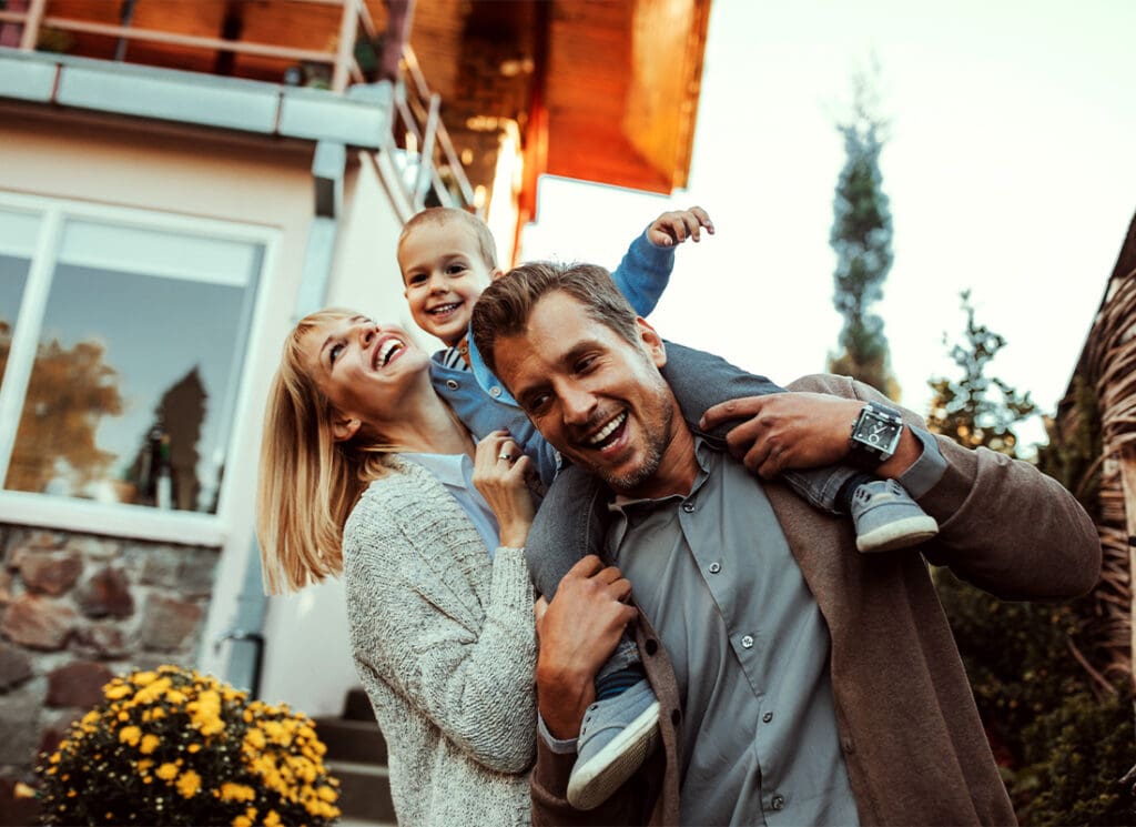 Insurance Solutions - Mother and Father Holding Their Small Child While Outside