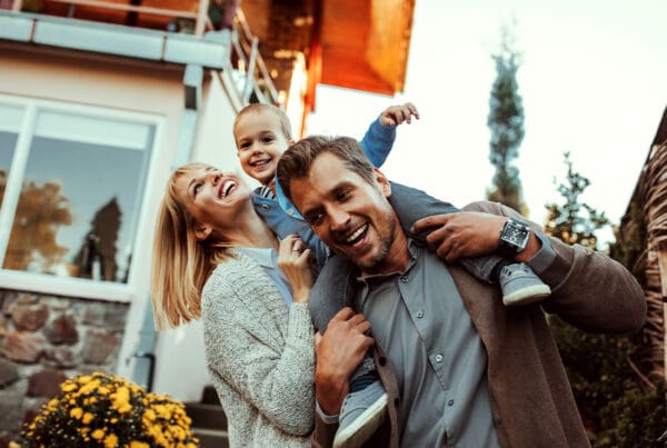 Insurance Solutions - Mother and Father Holding Their Small Child While Outside