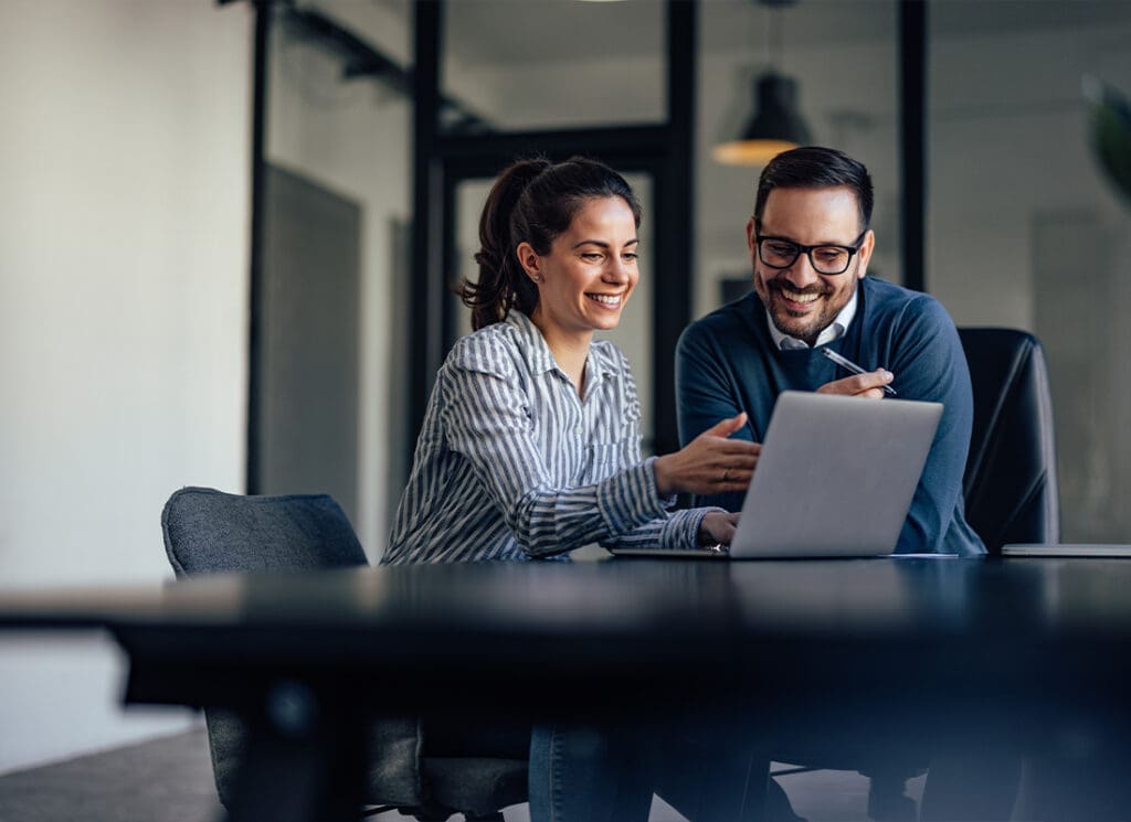 Client Portal - Two Business Colleagues Looking at Something Online