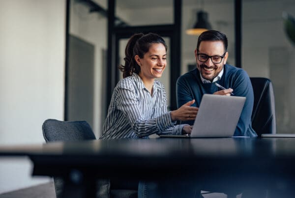Client Portal - Two Business Colleagues Looking at Something Online