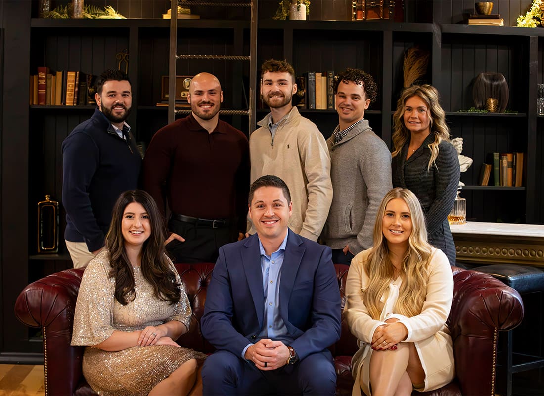 Contact page - Team Photo of Innovators Insurance Agents Smiling in Front of Bookcase in Library